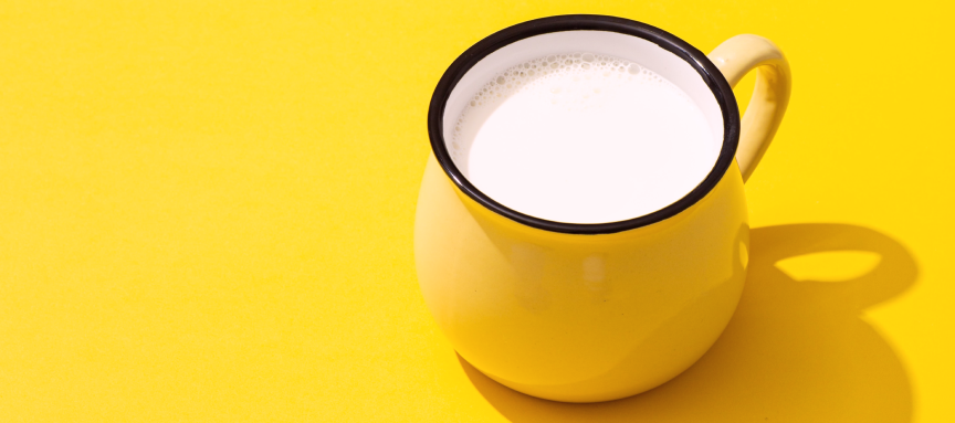 Cup of milk on a yellow table