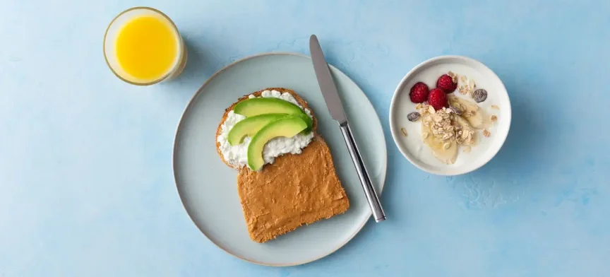 Whole wheat bread with peanut butter, cottage cheese and avocado, yoghurt and orange juice