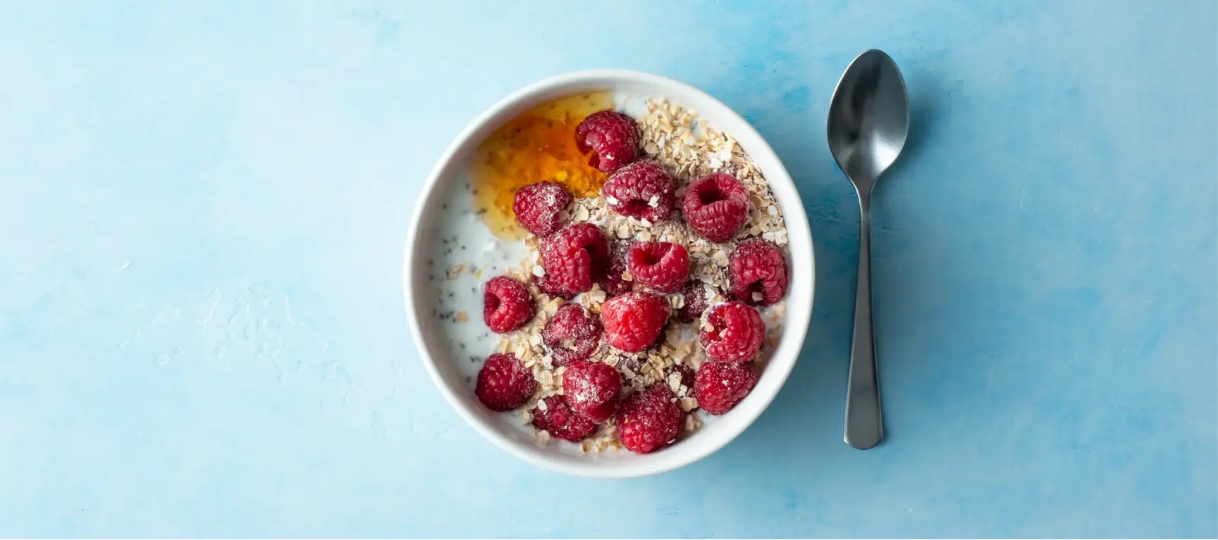 Low-fat Greek yoghurt with honey, chia seeds, raspberries, and oatmeal