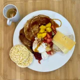 Mango coco pancakes with syrup, quark and fruit