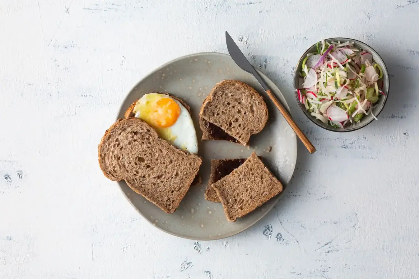 Whole wheat bread with fried eggs and whole wheat bread with apple syrup plus salad